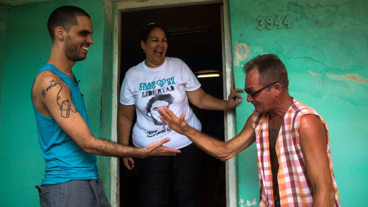 Graffiti artist Danilo Maldonado Machado, left, with his mother and a friend in Havana in 2015.