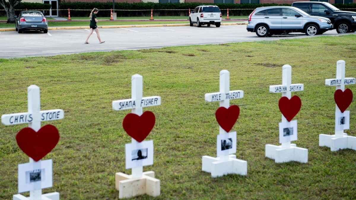 Crosses stand for the victims — two teachers and eight students — killed in the mass shooting May 18 at Santa Fe High School, outside of Houston.