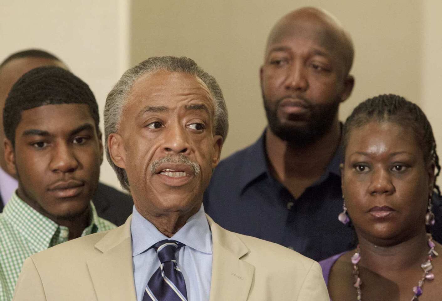 The Rev. Al Sharpton, with Trayvon Martin's parents, Tracy Martin and Sybrina Fulton, speaks out against the judge's decision to allow bail. Fulton said she was disappointed.