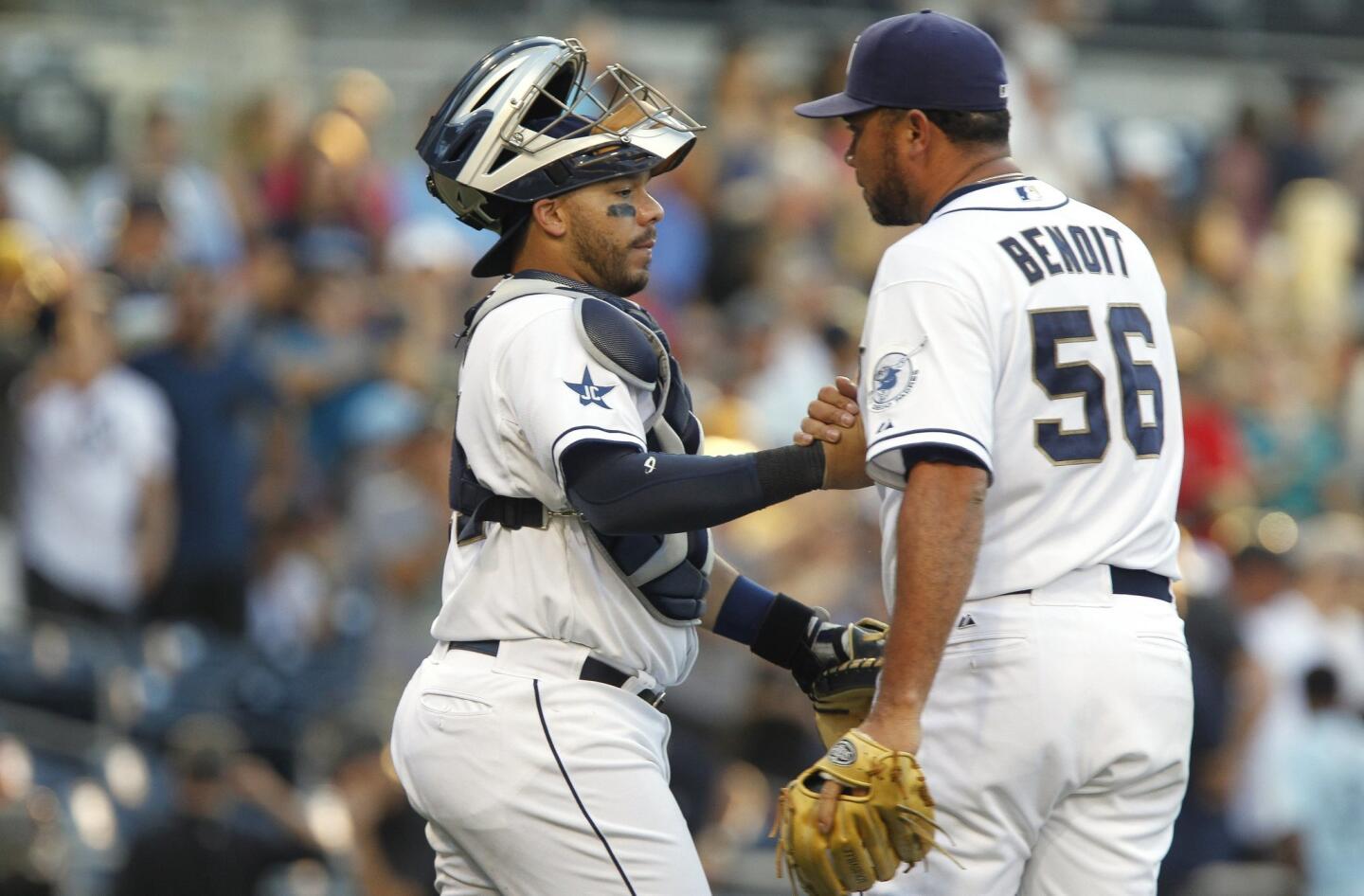 The Padres' closing pitcher Joaquin Benoit and catcher Rene Rivera celebrate the Padres 5-3 win to sweep the Rockies.