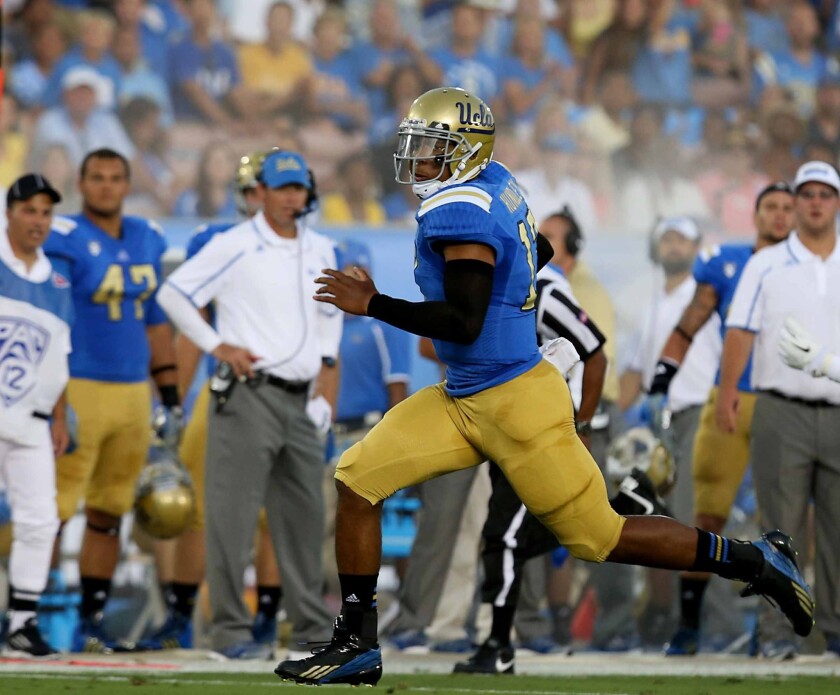 UCLA quarterback Brett Hundley breaks away to score a first-quarter touchdown against Nevada on Saturday.