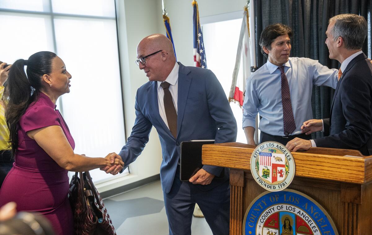 Officials attend a press conference where a $236 million settlement was announced.