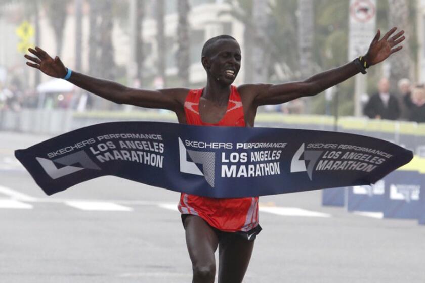 Elisha Barno crosses the finish line in Santa Monica to win the 32nd annual L.A. Marathon men's race.