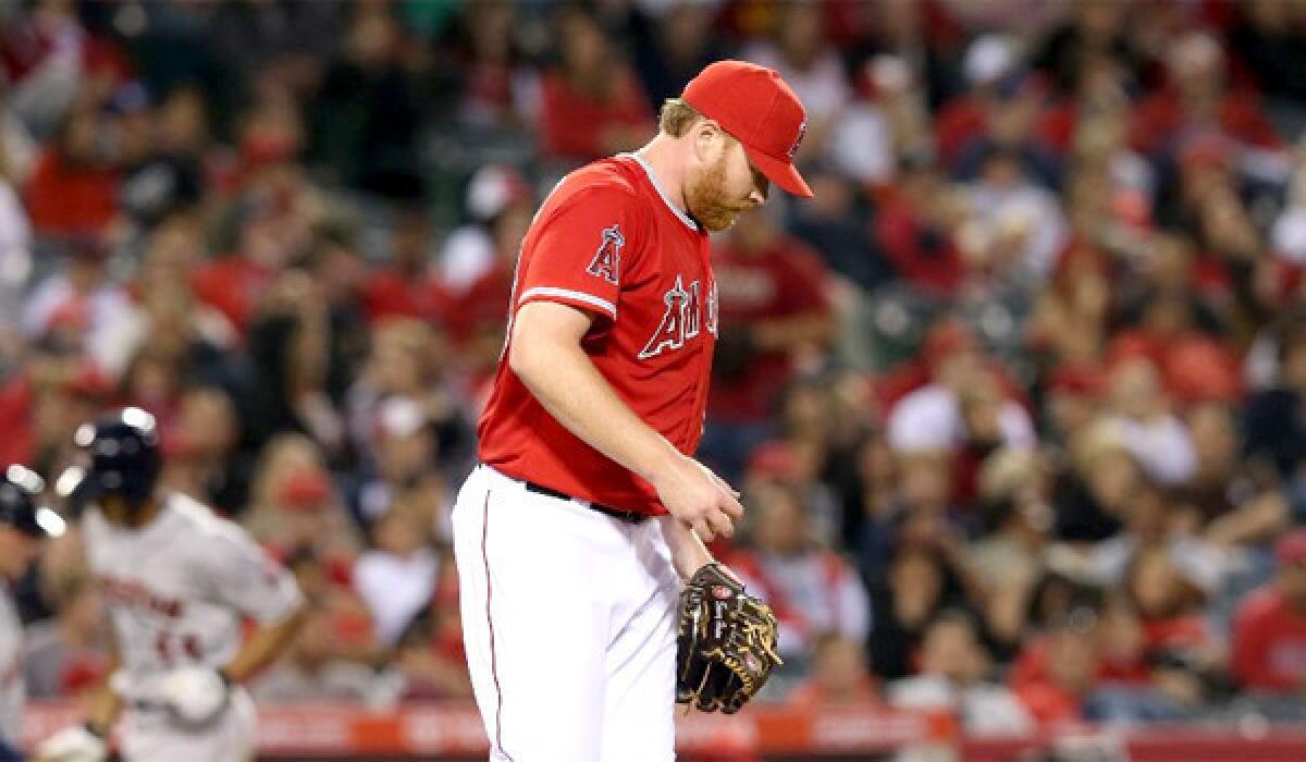 Pitcher Tommy Hanson reacts as Justin Maxwell circles the bases after hitting a solo home run in the second inning of the Angels' 5-0 loss to the Houston Astros.