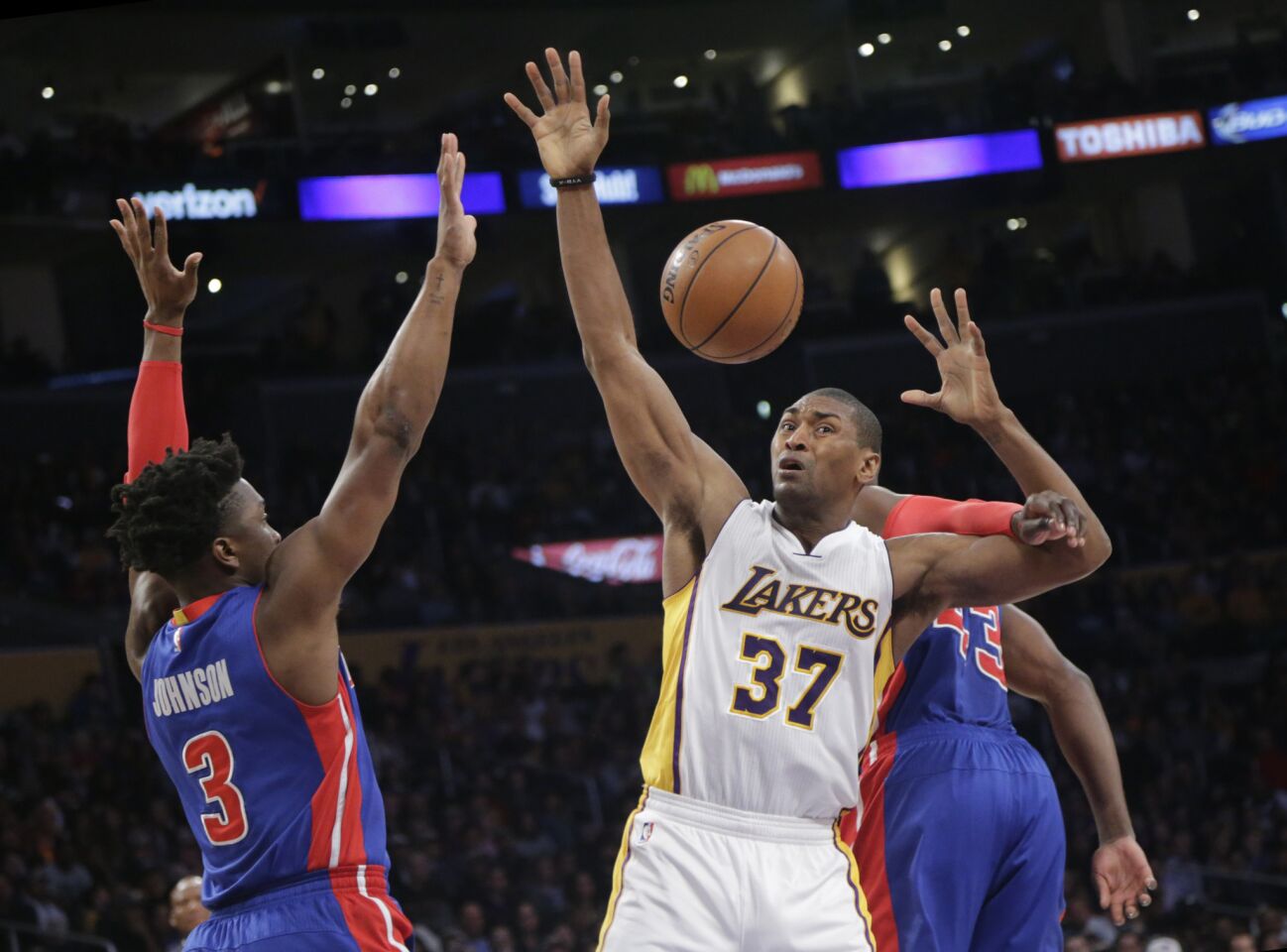 Lakers forward Metta World Peace is fouled by Pistons forward Anthony Tolliver while working against forward Stanley Johnson in the first half.