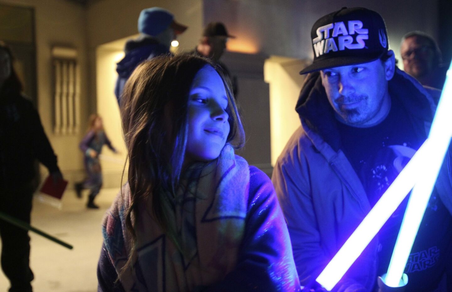 ESCONDIDO, December 30, 2016 | William Piitts, from Poway, and daughter Triniti, 10, hold their lightsabers as they and other Star Wars fans gather at the California Center for the Arts in Escondido to pay tribute to actress Carrie Fisher on Friday | Photo by Hayne Palmour IV/San Diego Union-Tribune/Mandatory Credit: HAYNE PALMOUR IV/SAN DIEGO UNION-TRIBUNE/ZUMA PRESS San Diego Union-Tribune Photo by Hayne Palmour IV copyright 2016