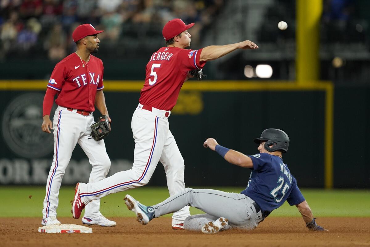 Marcus Semien of the Texas Rangers throws to first base in the