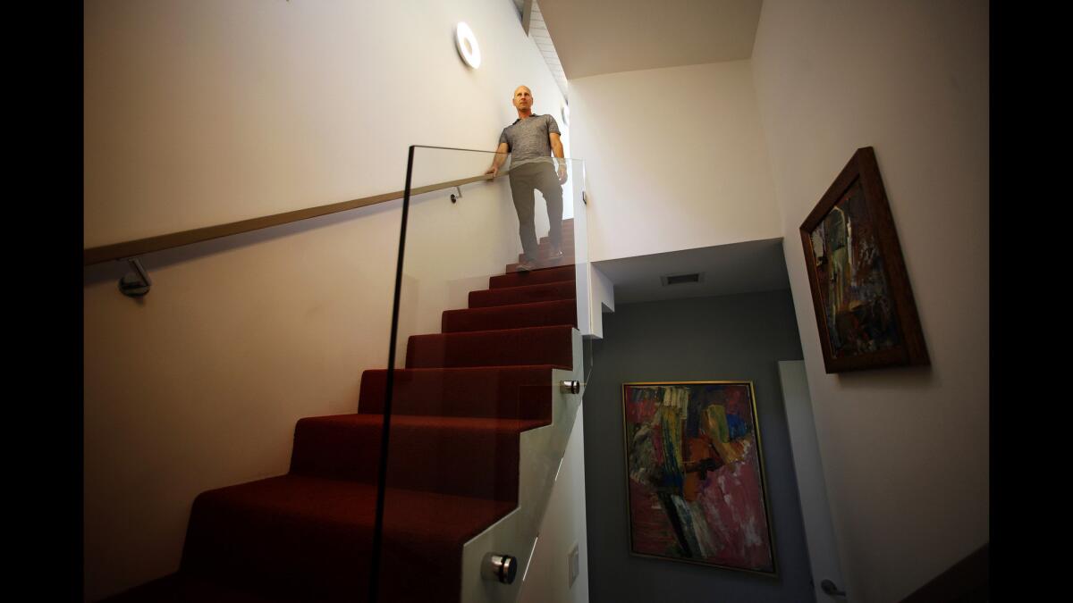 Architect Todd Conversano on the staircase that leads to the master bedroom addition, a separate structure above the original house.