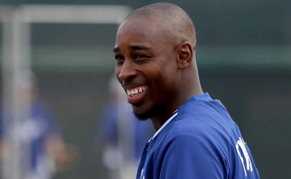 Dodgers infielder Chone Figgins smiles during a team batting practice session at the Dodgers' practice facility in Glendale, Ariz., on Tuesday. Figgins understands he'll have to stand out in spring training if he has any hope of making the opening day roster.