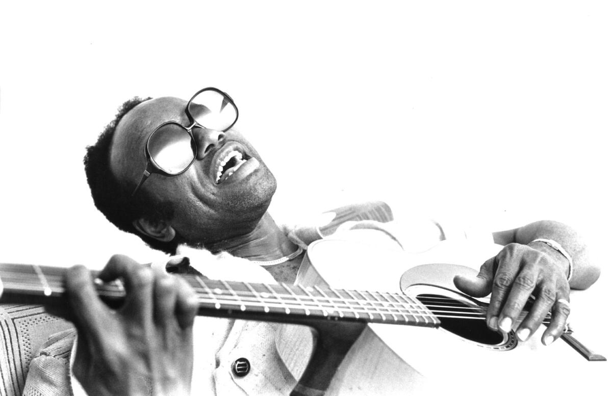 Guitarist and singer Bobby Womack plays acoustic guitar as he poses for a portrait circa 1982 in London. Womack died on Friday at 70.