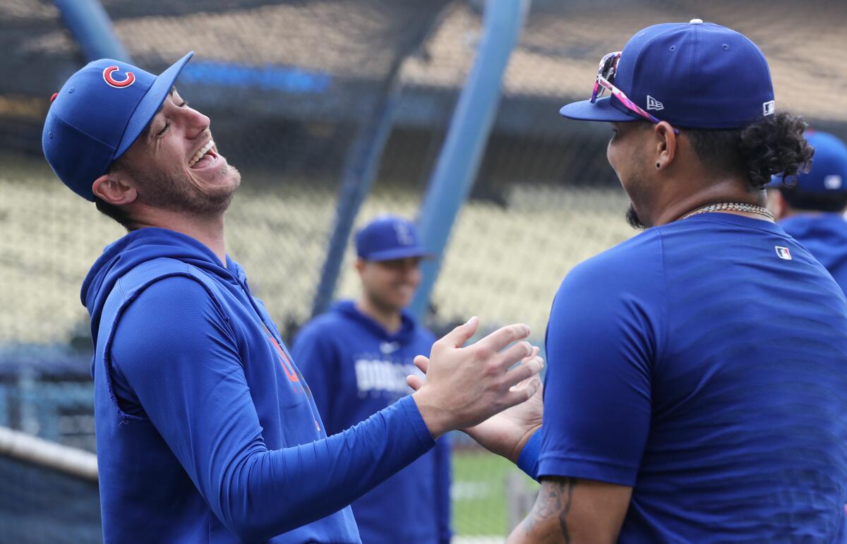 Chicago Cubs center fielder Cody Bellinger, left, visits with Dodgers pitcher Brusdar Gaterol.
