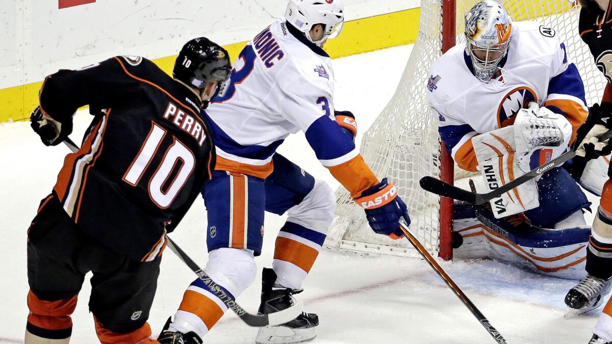 Right wing Corey Perry slips a shot past Islanders goalie Thomas Greiss in the second period for the Ducks' only score Friday night.