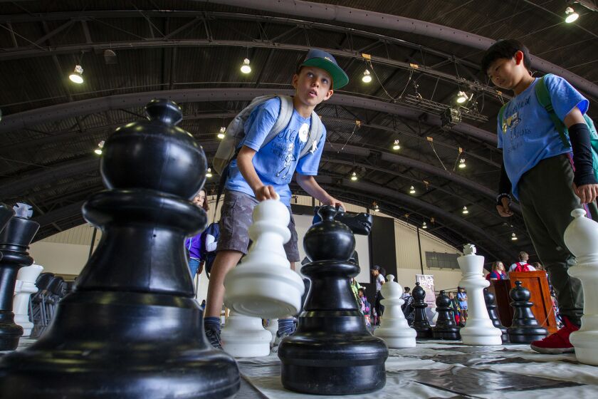 Neo Nasstrom, 10, left, and Shu Guo, 10, play chess on a giant board during Imaginology on Friday, April 13.