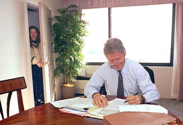 Chelsea Clinton peeks in on her dad as he works on his presidential debate notes in Ypsilanti, Mich., in October 1992.