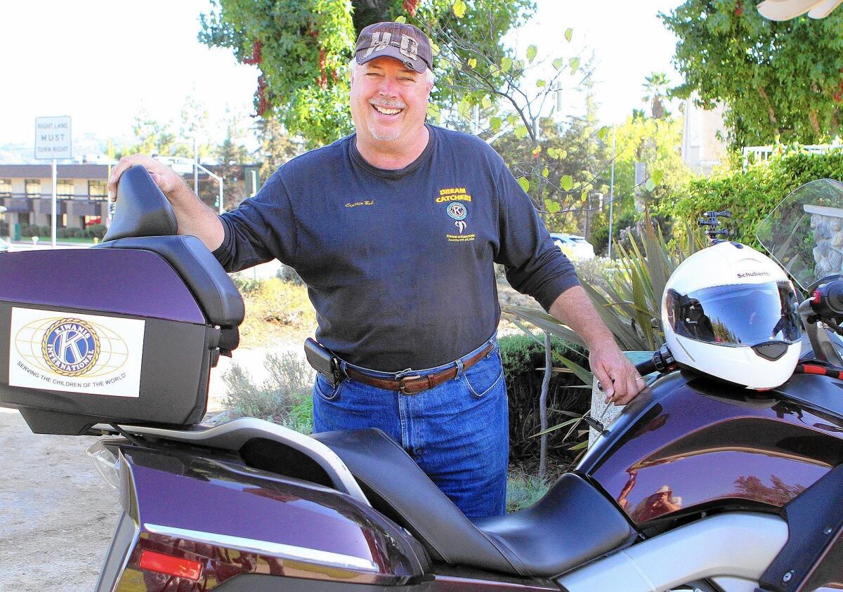 Robert Burlison, Jr. stands with his motorcycle preparing to recite a few lines for a DVD being produced at Memorial Park in La Canada Flintridge on Monday, September 29, 2014. Robert Burlison Jr. organized the ride called KURE where he and fellow Kiwanians set a record for their cross-country tour to raise money to eliminate tetanus world wide.