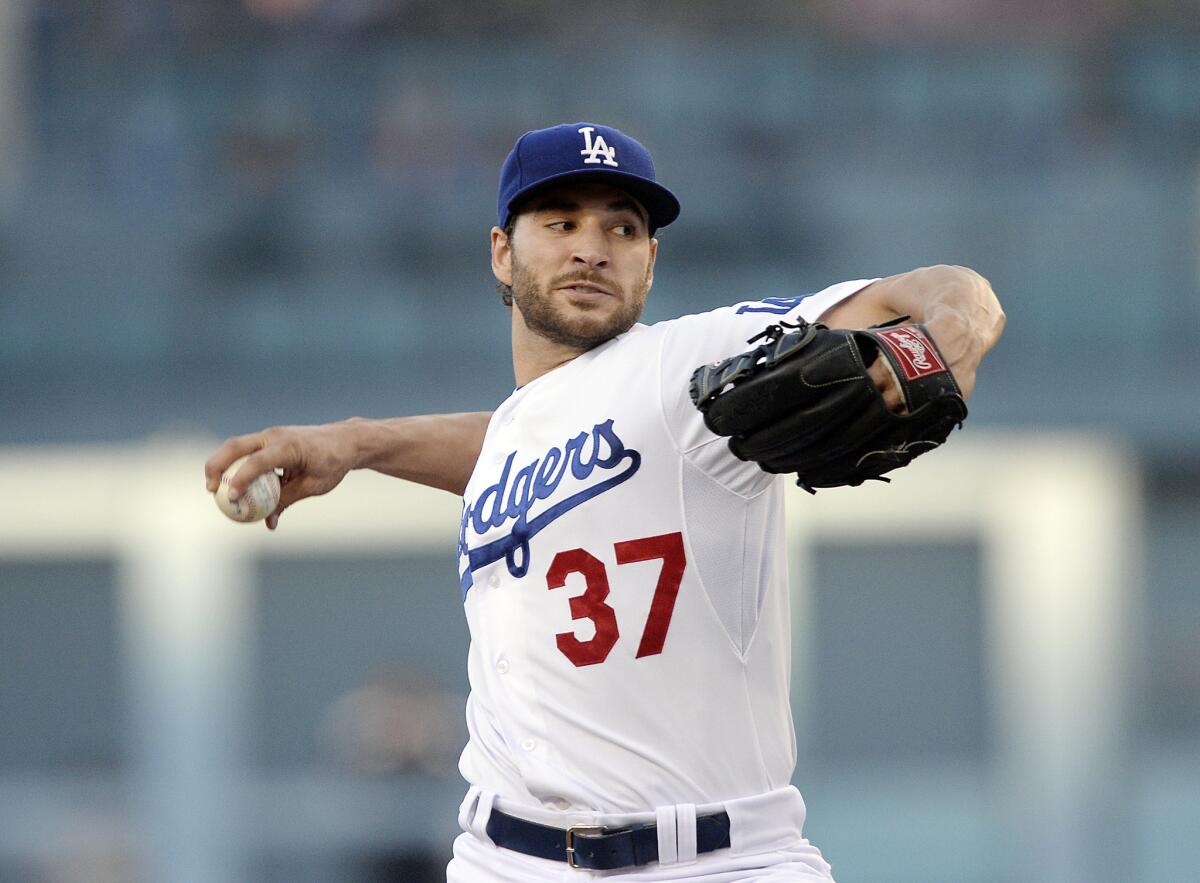 Dodgers starter Brandon Beachy delivers a pitch against the Brewers in the first inning Saturday night, completing his return from a second ligament replacement surgery on his right elbow.