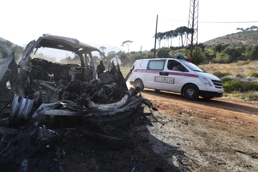 Una ambulancia pasa junto a un vehículo quemado en la localidad de Masyaf, Siria, el lunes 9 de septiembre de 2024. (AP Foto/Omar Sanadiki)