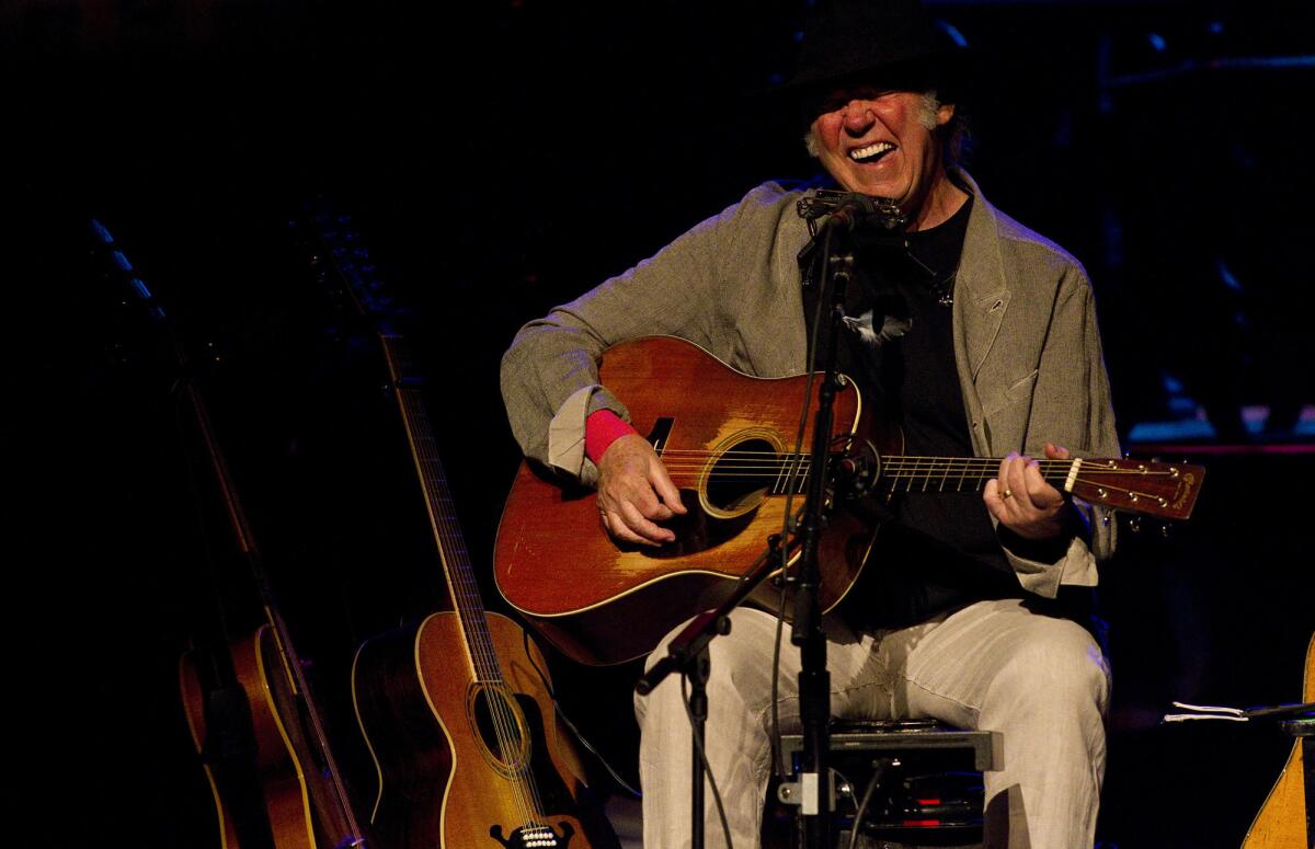 Neil Young, shown performing in March in Hollywood, has released three different versions of a new ecologically conscious song, "Who's Gonna Stand Up?"