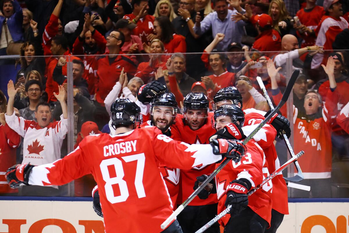Sydney Crosby, left, and Brad Marchand, right, and other Team Canada members celebrate against Russia on Sept. 24.