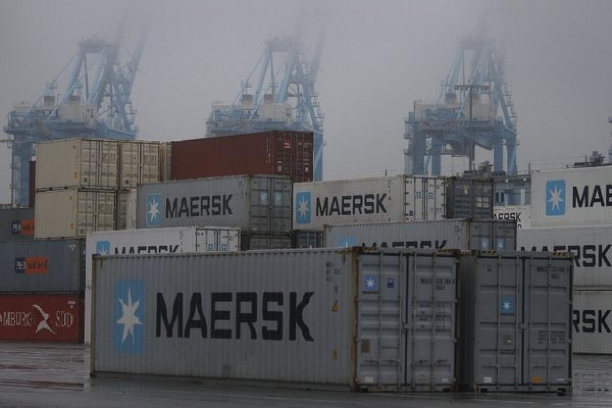 Fog shrouds the normally busy cranes at the APM Terminal at the Port of Los Angeles. The strike that has idled 10 of 14 cargo container terminals at the ports of L.A. and Long Beach began here last Tuesday.