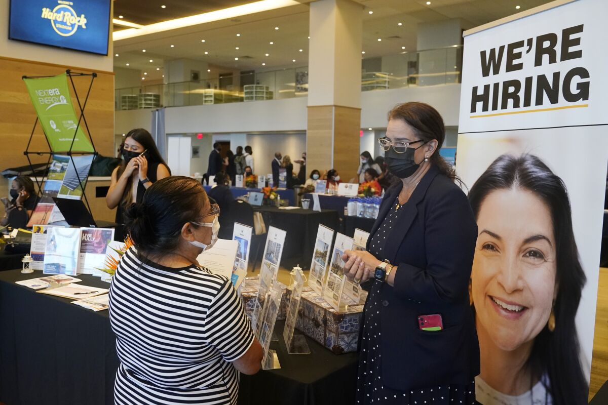 FILE - Marriott human resources recruiter Mariela Cuevas, left, talks to Lisbet Oliveros, during a job fair at Hard Rock Stadium, Friday, Sept. 3, 2021, in Miami Gardens, Fla. The number of Americans applying for unemployment benefits fell to a new pandemic low 267,000 last week, another sign that the job market is recovering from last year’s sharp coronavirus downturn. Jobless claims fell by 4,000 last week, the Labor Department reported Wednesday, Nov. 10. (AP Photo/Marta Lavandier, File)