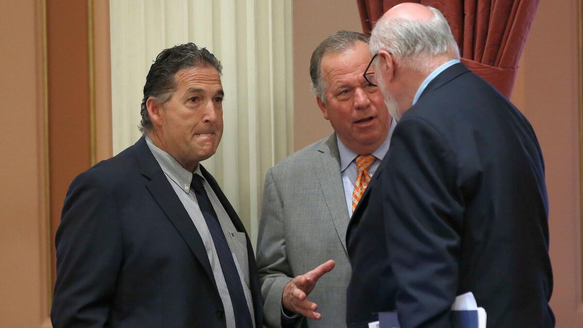 Sen. Bill Dodd (D-Napa), center, has authored a bill designed to allow customers to sue their banks over unauthorized accounts. (Rich Pedroncelli / AP)