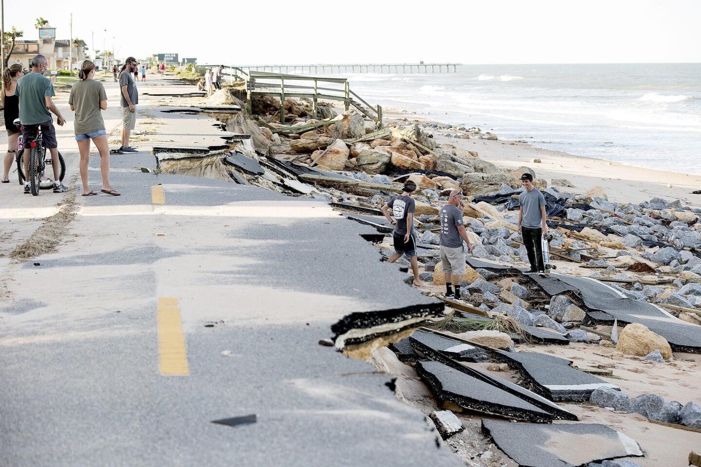 Beachgoers check out damage left by Hurricane Matthew along historic State Road A1A in Flagler County, Fla., on Oct. 8, 2016.