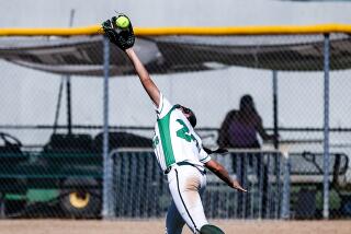 Center fielder Jeniece Jimenez of Granada Hills makes a running catch of a fly ball during her team's 6-0 win over ECR.