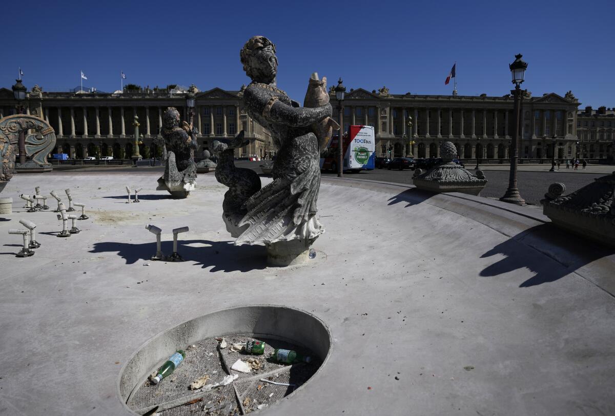 The fountains of Concorde plaza are empty in Paris, France, as Europe is under an extreme heat wave on Wednesday, Aug. 3, 2022. Paris' regional authorities warned residents to be vigilant Wednesday, with temperatures soaring to 36 degrees Celsius (97 Fahrenheit). (AP Photo/Francois Mori)