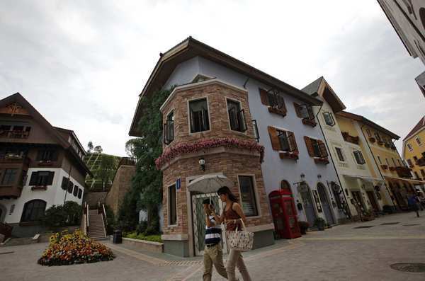 Visitors walk by European-style homes in the Hallstatt development. Reactions to the Chinese replica from Hallstatt residents have been mixed, but an Austrian delegation that included the town's mayor attended the development's opening ceremony.