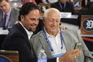 Former Los Angeles Dodgers' Mike Piazza, left, and Tommy Lasorda take a picture of themselves before the 2014 MLB baseball draft, Thursday, June 5, 2014, in Secaucus, N.J. (AP Photo/Bill Kostroun)