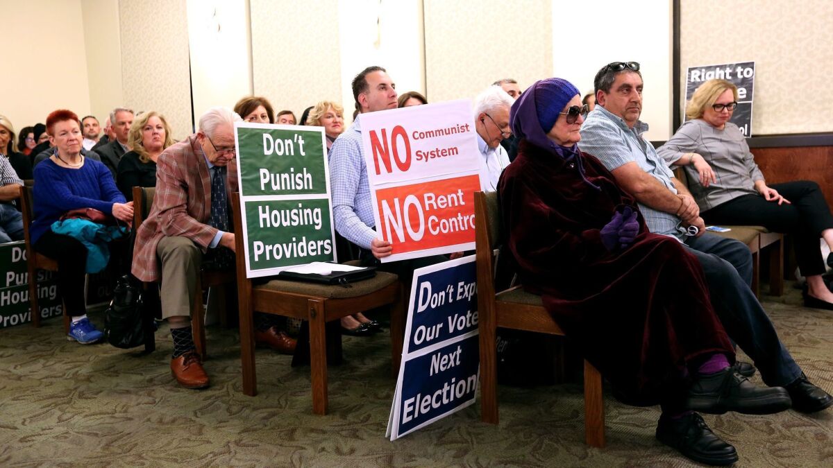 Signs for and against increased renter protections were held during a Glendale City Council discussion about a proposed Right to Lease ordinance.
