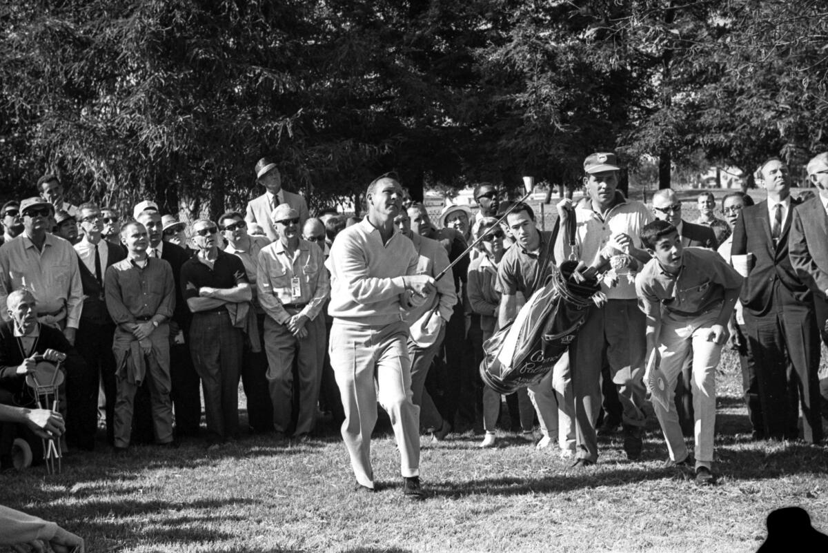 Arnold Palmer and his fans watch the flight of a ball during L.A. Open golf tournament. 