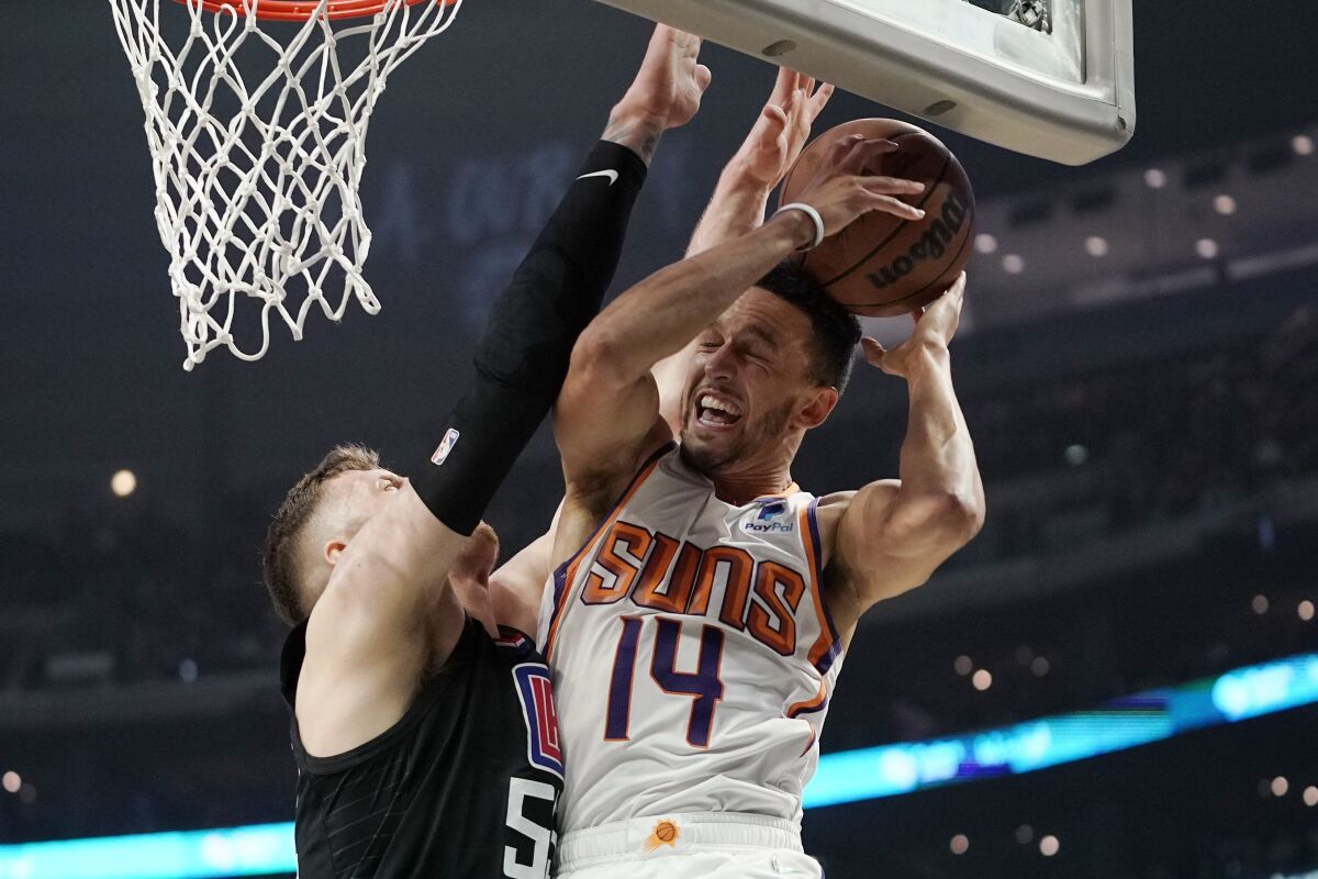 Phoenix Suns guard Landry Shamet tries to shoot as Clippers center Isaiah Hartenstein defends.