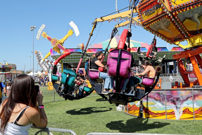 Festival-goers spin around on the Tornado ride during Summerfest at Fountain Valley Sports Park on Saturday.