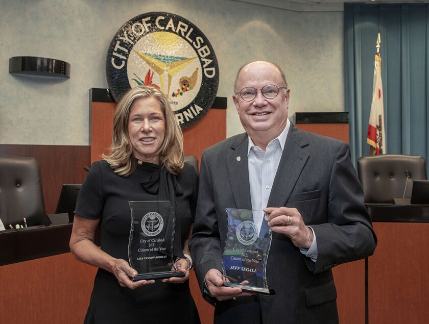 Lisa Cannon-Rodman and Jeff Segall hold their awards for being chosen as Carlsbad 2021 Citizens of the Year.