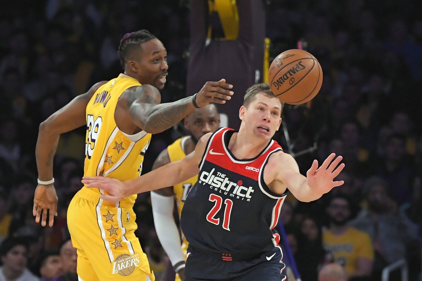 Wizards forward Moritz Wagner and Lakers center Dwight Howard reach for the ball during the first half of a game Nov. 29 at Staples Center.