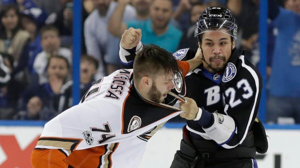 Lightning right wing J.T. Brown and Ducks left wing Joseph Cramarossa fight during the first period of a game in Tampa, Fla. on Feb. 4.