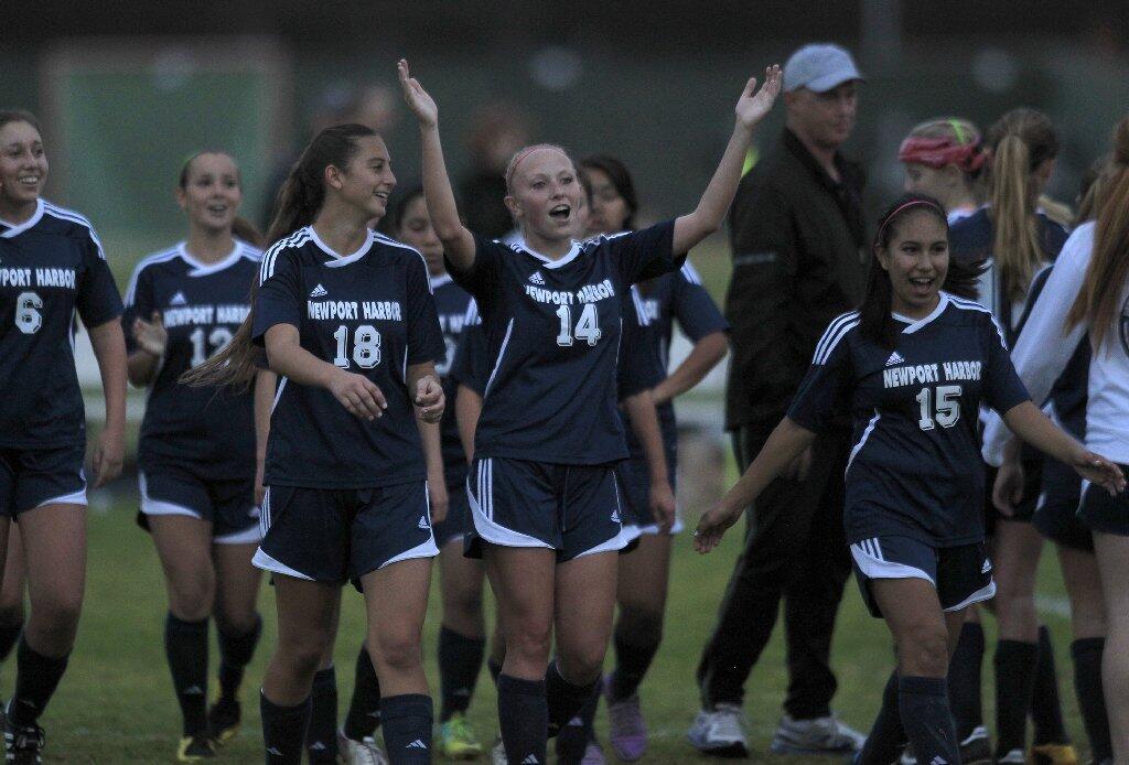 Newport Harbor High's Jessica Prather (14), Rosalie Deliz (18) and Melisa Camano (15) celebrate after the Sailors beat Corona del Mar, 3-2, in the Battle of the Bay soccer match on Tuesday.