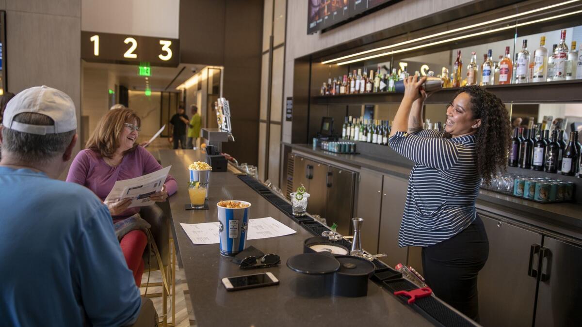 Bartender Latashia Parker mixes a drink for movie goers at Cinepolis Luxury Cinemas newest movie theater, The Bay Theatre by Cin?polis Luxury Cinemas, in Palisades Village.