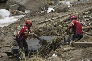 Firefighters clear debris as they search for survivors where homes were swept away overnight by a swollen Naranjo River after heavy rain in the "Dios es fiel," or "God is Loyal" shanty on the outskirts of Guatemala City, Monday, Sept. 25, 2023. (AP Photo/Moises Castillo)