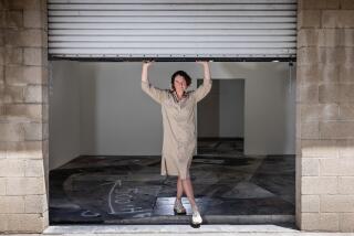 Glendale, CA - August 16: Artist Fionna Connor is photographed at the garage door of her Glendale, CA, studio, Wednesday, Aug. 16, 2023, days before her newest show is open to the public, titled, "Continuous Sidewalk, 2021-2023." Connor's current work, presented by gallery Chateau Shatto, is recreating 23 different squares of segments of sidewalk located in the Civic Center of downtown Los Angeles. (Jay L. Clendenin / Los Angeles Times)