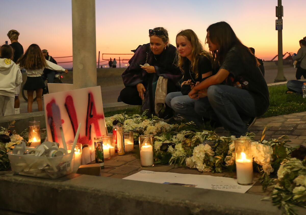 Friends gather at a candlelight shrine in honor of 15-year-old Aayan Randhawa on Tuesday night.