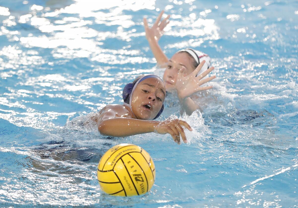 Newport Harbor's Angie Peterson fends off a CdM defender near the net during the annual Battle of the Bay on Thursday.