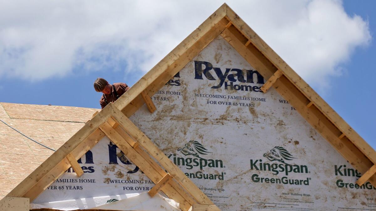 A builder works on the roof of a home under construction in Jackson Township, Pa.