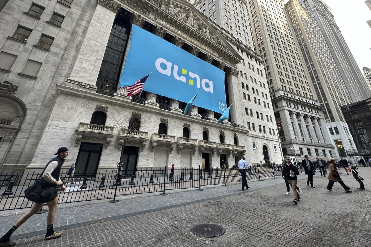 People walk past the New York Stock Exchange Wednesday, April 10, 2024 in New York. 