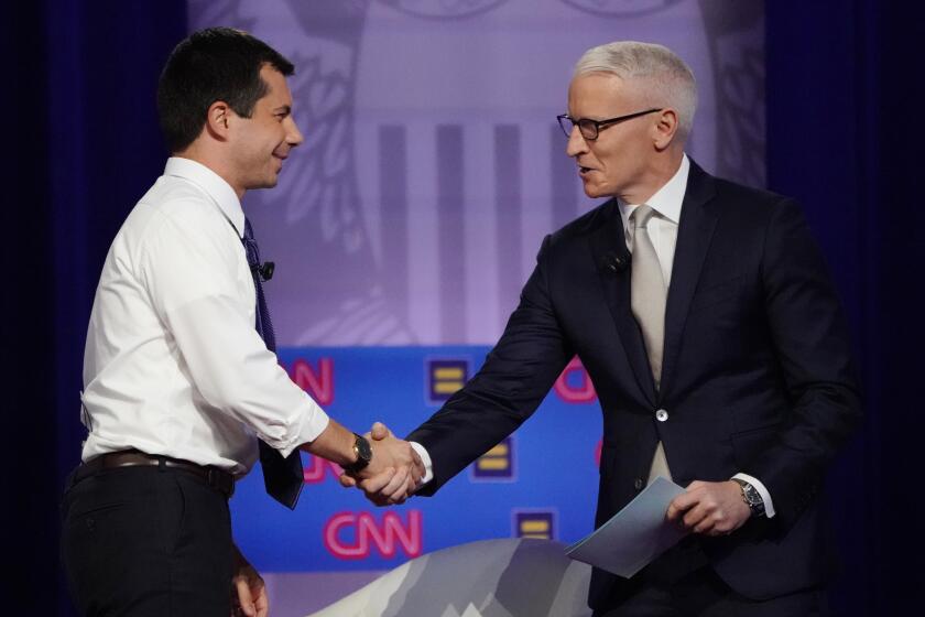 LOS ANGELES, CALIFORNIA - OCTOBER 10: Democratic presidential candidate South Bend, Indiana Mayor Pete Buttigieg (L) shakes hands with CNN moderator Anderson Cooper at the Human Rights Campaign Foundation and CNN’s presidential town hall focused on LGBTQ issues on October 10, 2019 in Los Angeles, California. It is the first Presidential event broadcast on a major news network focused on LGBTQ issues. (Photo by Mario Tama/Getty Images)