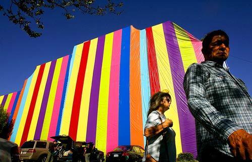 Passersby at the Pasadena Museum of California Art stand under a towering new installation, which looks like a Frank Stella-esque fumigation tent and represents the intersection of art and architecture. The installation is called Inside Out.