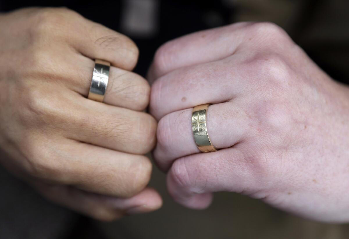The U.S. Supreme Court is expected to rule this month in a lawsuit that challenged the constitutionality of the gay marriage ban, known as Proposition 8. Above: Thom Watson, right, and Jeff Tabaco show the rings which they exchanged during their 2009 wedding ceremony at their home in Daly City.