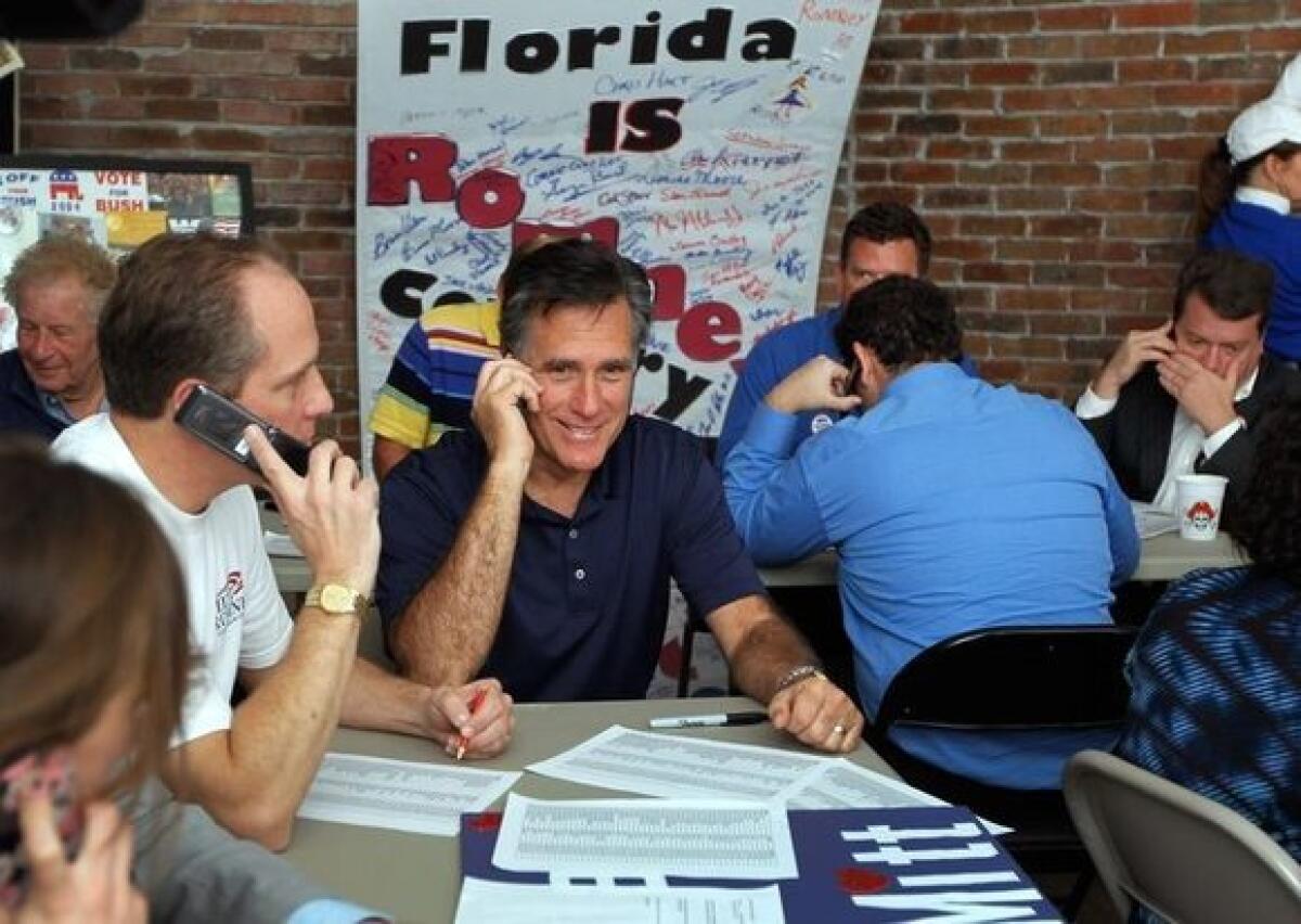 Mitt Romney works the phones at his campaign headquarters in Tampa, Fla., on Tuesday.